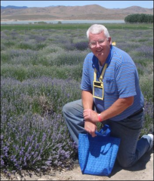 No joke! Mike Simons, kneeling next to one lavender field at the Young Living Farm in Mona, Utah