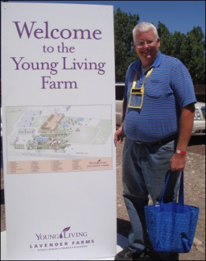No joke! Mike Simons, standing next to the sign at the entrance to the Young Living farm in Mona, Utah, in July 2013.