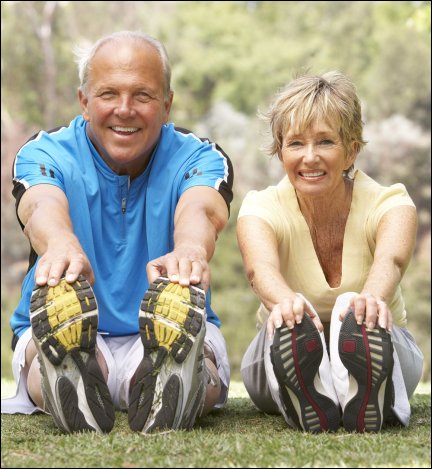 Senior couple exercising in park, symbolizing essential oil wellness.