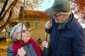 An elderly couple, retirees and grandparents, who are in their retirement years. Can retirees enjoy retirement years fully without financial worries?